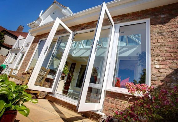 Open conservatory doors onto a garden