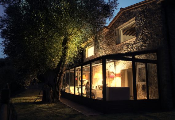 A lit up conservatory at night looking picturesque