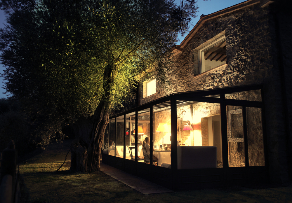 A lit up conservatory at night looking picturesque