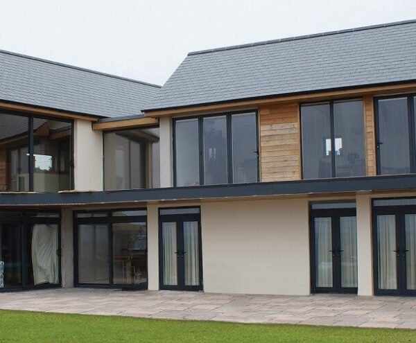 Modern aluminium doors with slim frames and large glass panels installed on a contemporary home.