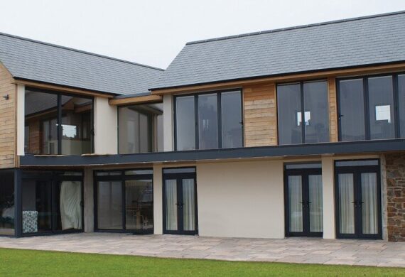 Aluminium patio doors with slim modern frames and large glass panels opening onto a garden.
