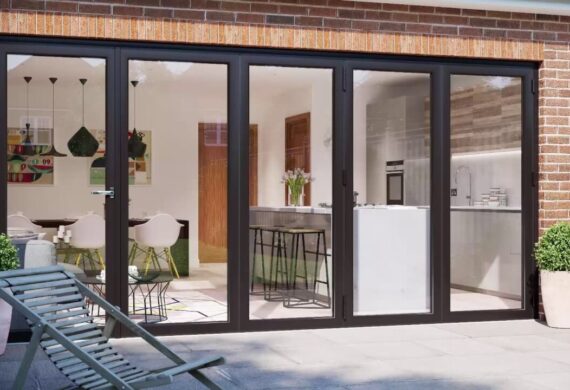 Aluminium bi‑fold doors with slim modern frames fully opening to connect indoor and outdoor spaces.
